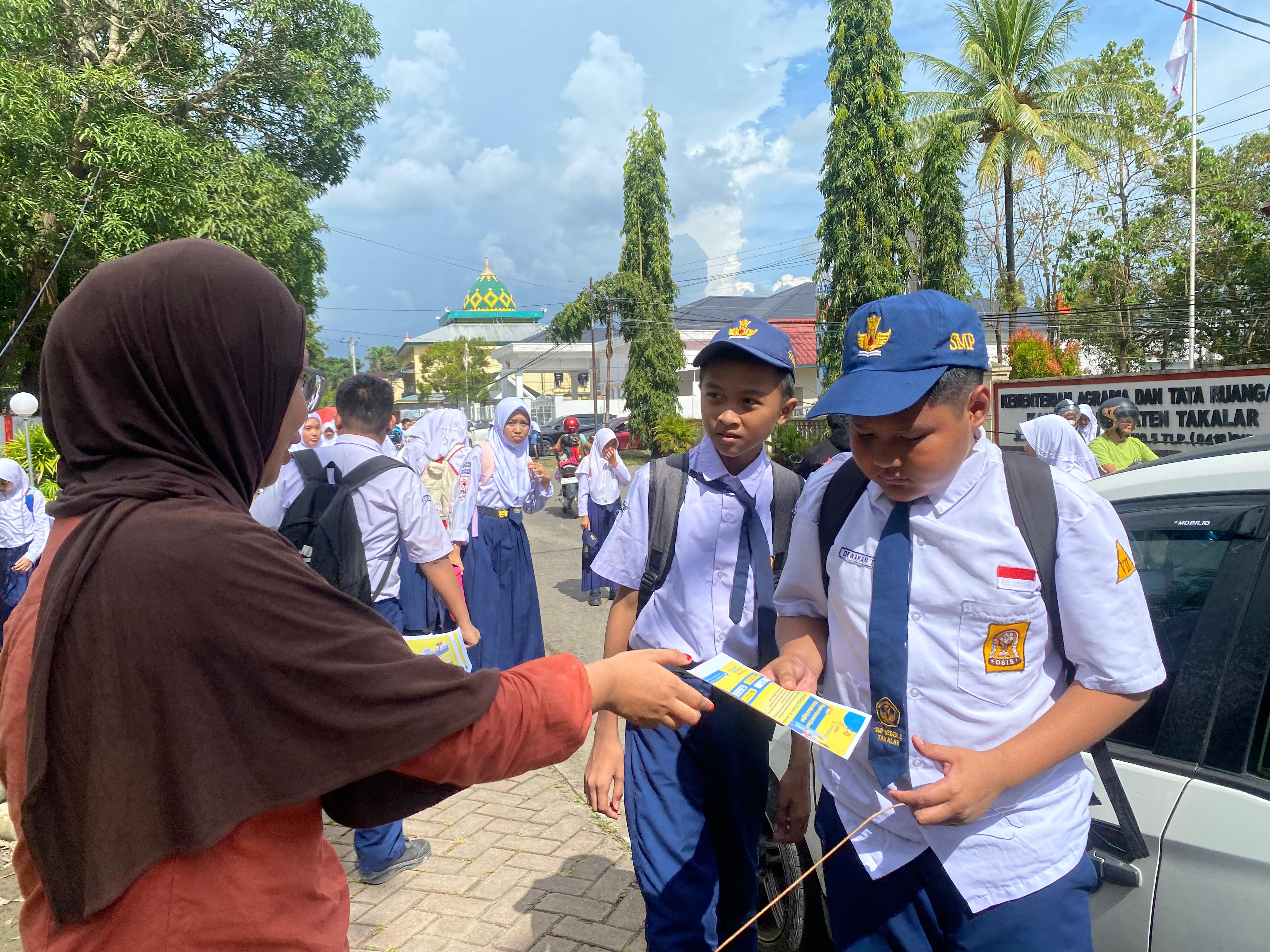 Bagi brosur ke siswa SMP 2 Takalar pada saat pulang sekolah 